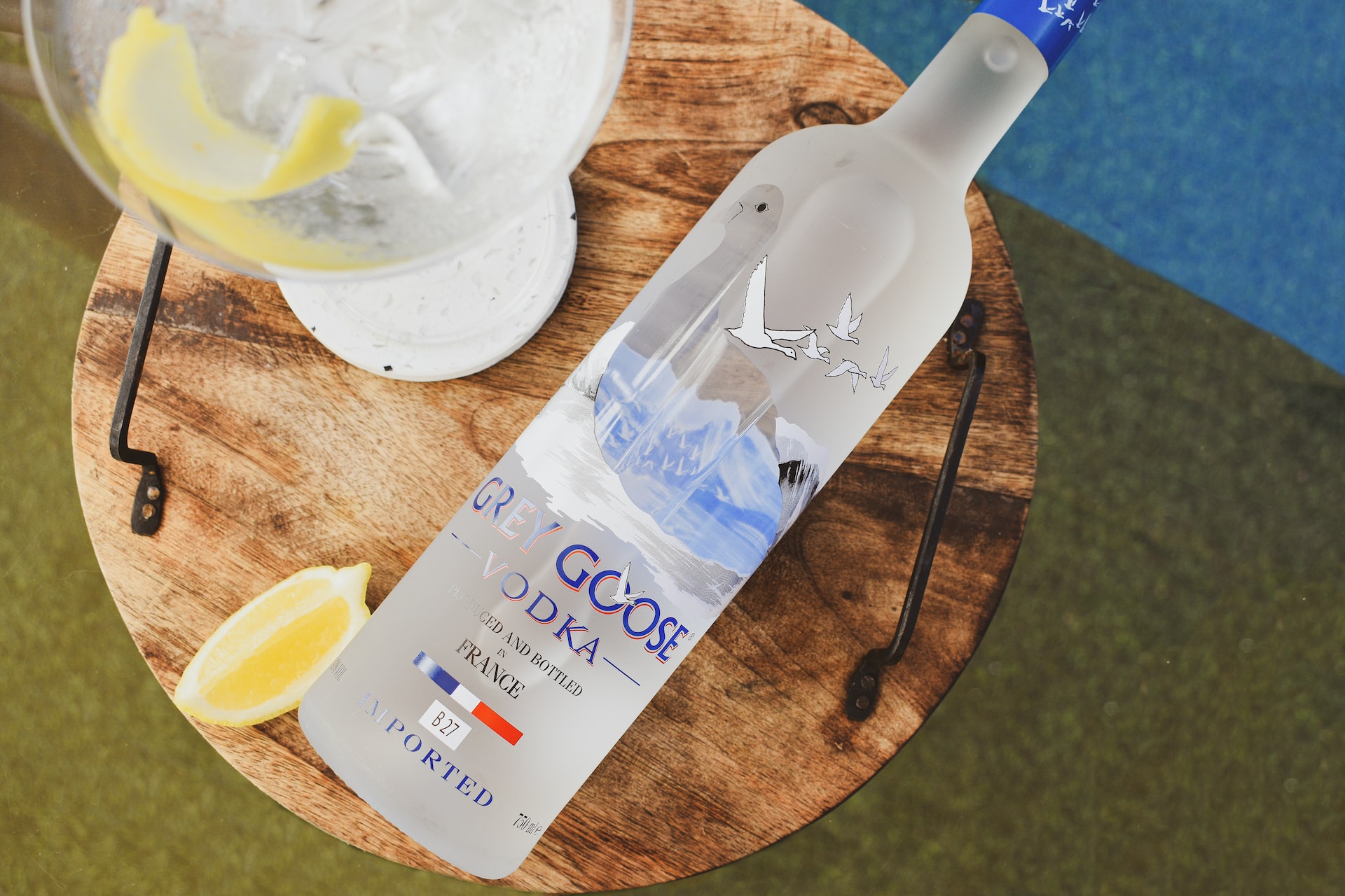 a bottle of vodka sitting on top of a wooden table